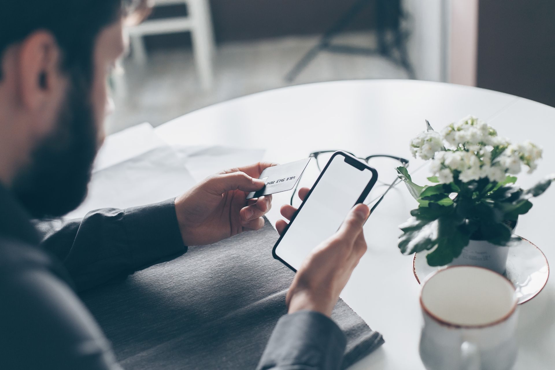 Person making an online payment using a smartphone, illustrating APP fraud and banking transactions