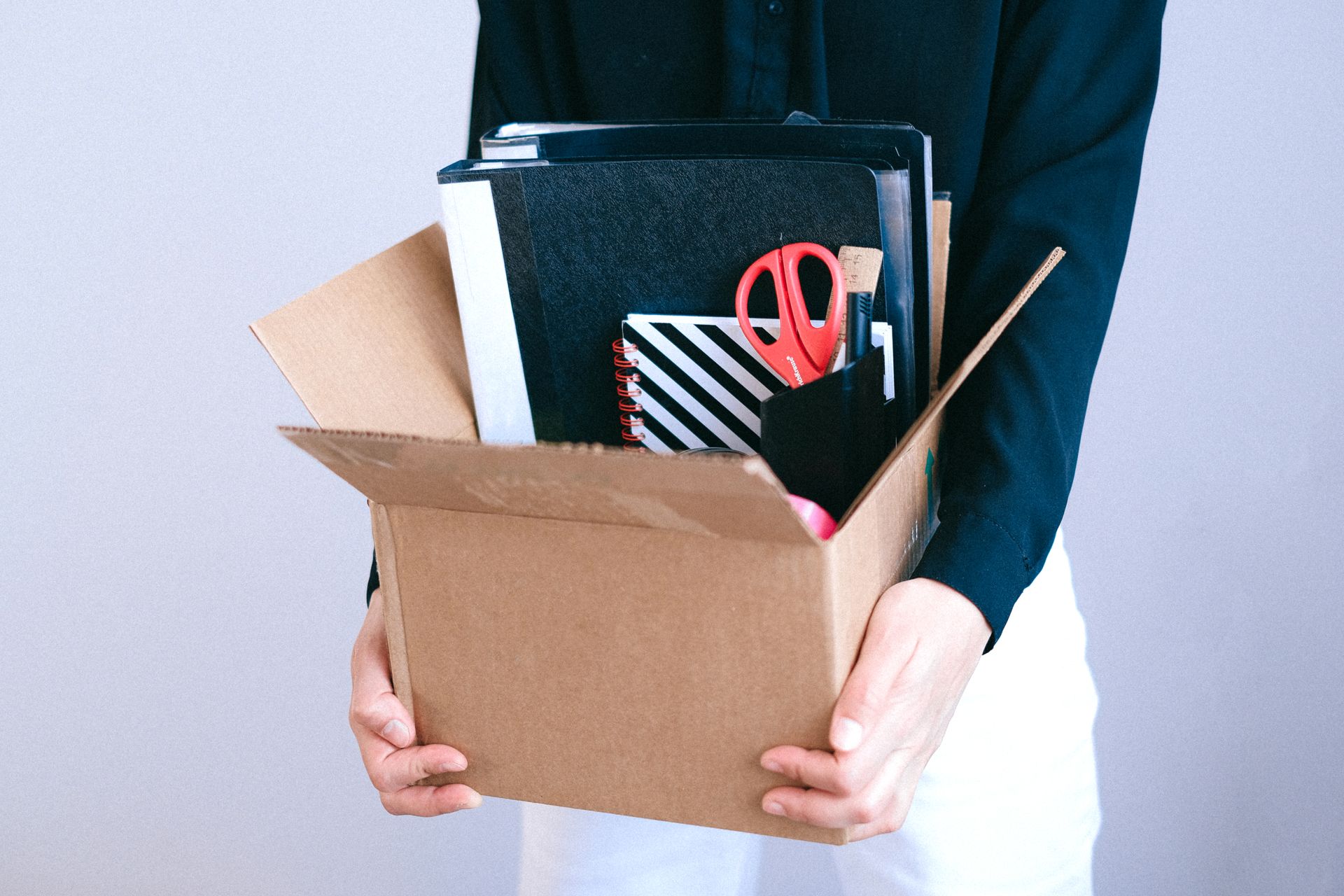 Woman with box of belongings after constructive dismissal